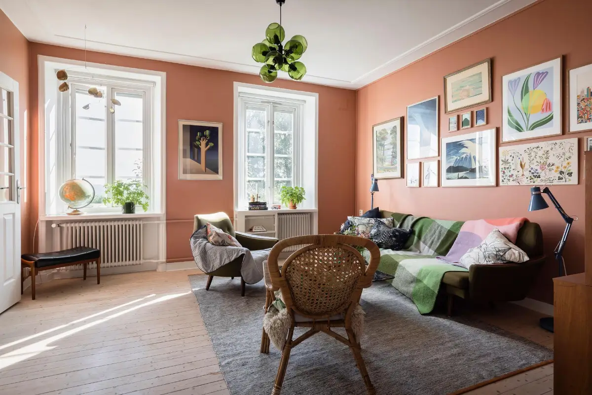 A Colorful 1920s Family Apartment in Sweden 4 terracotta living room green sofa gallery wall nordroom