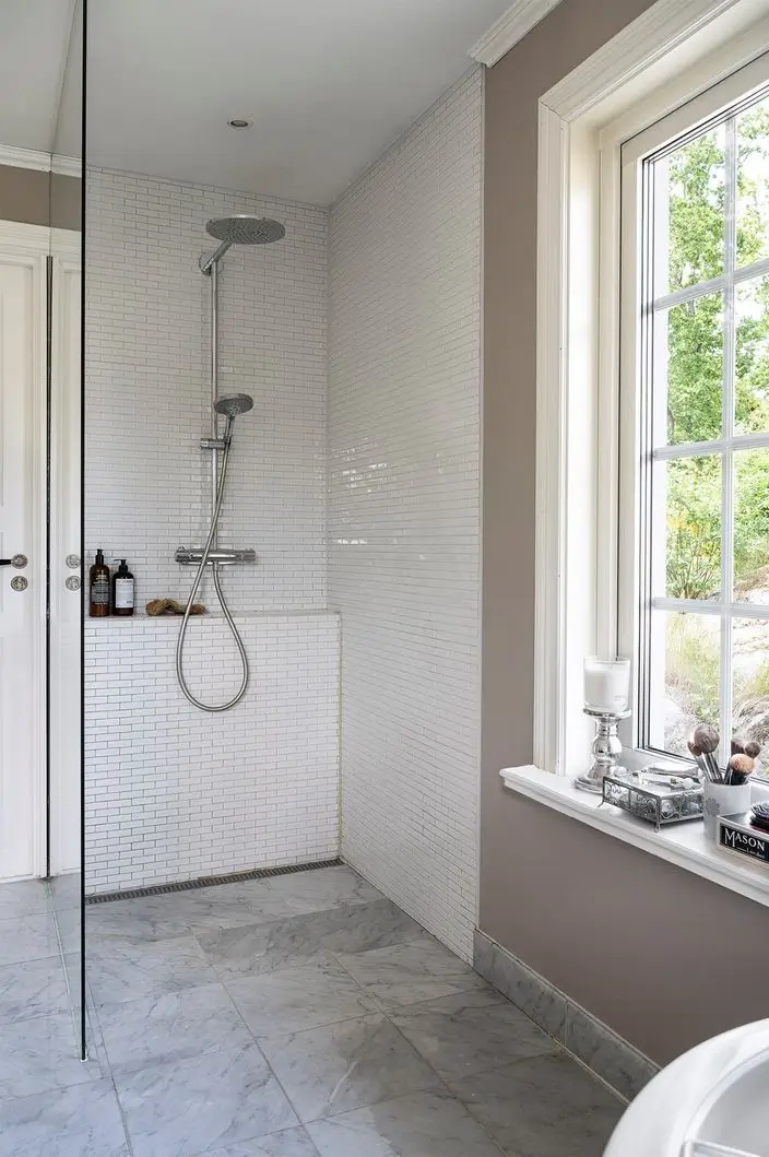 Scandinavian Design Meets The Hamptons in a Swedish Country House 48 walk-in shower marble floor tiles