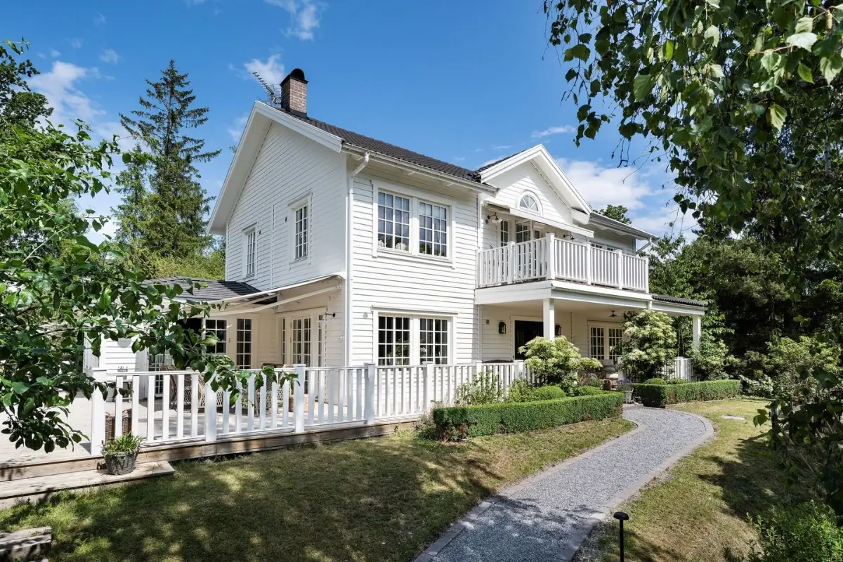Best of 2025: Architecture 23 white coastal-style swedish country house with veranda and balcony nordroom
