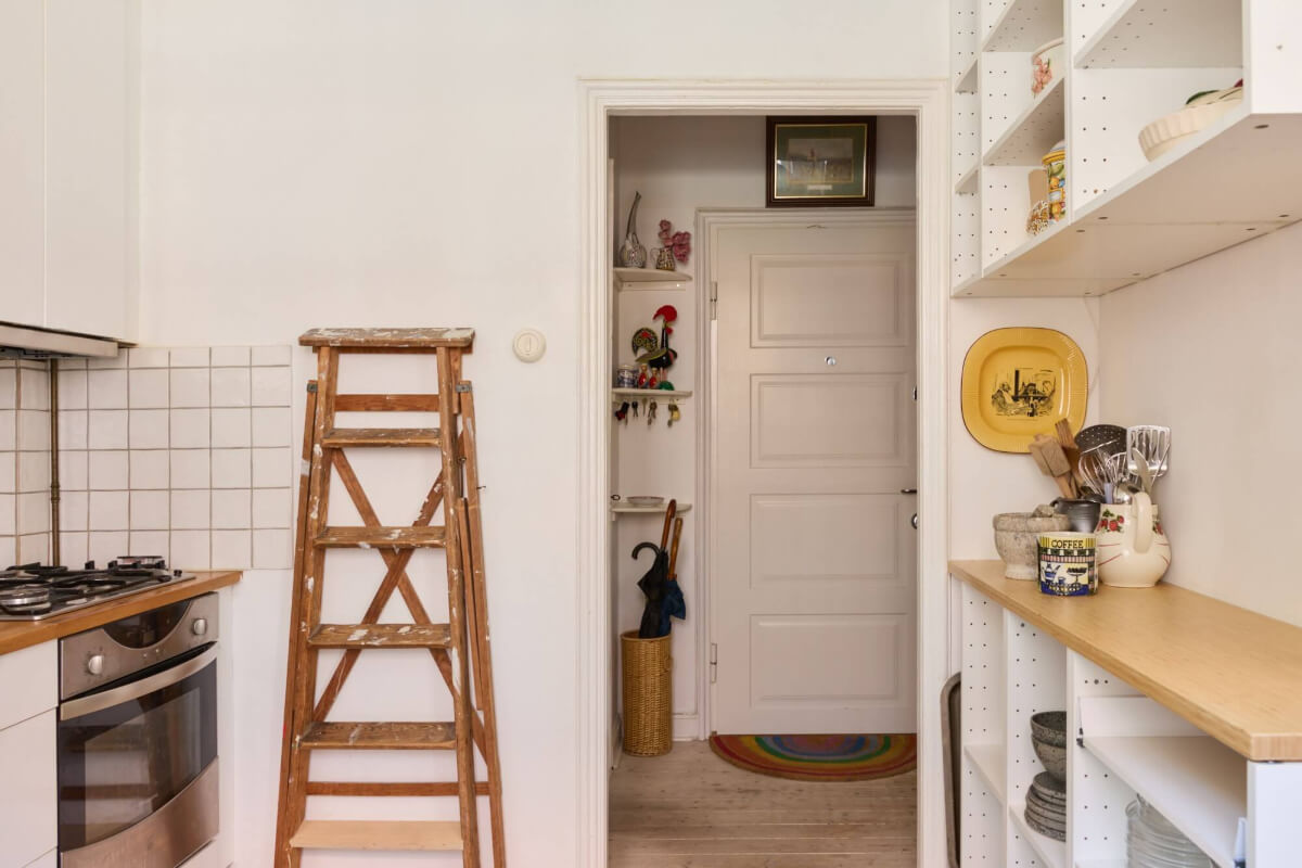 A Blue Living Room Filled with Art in a Swedish Apartment 11 white kitchen