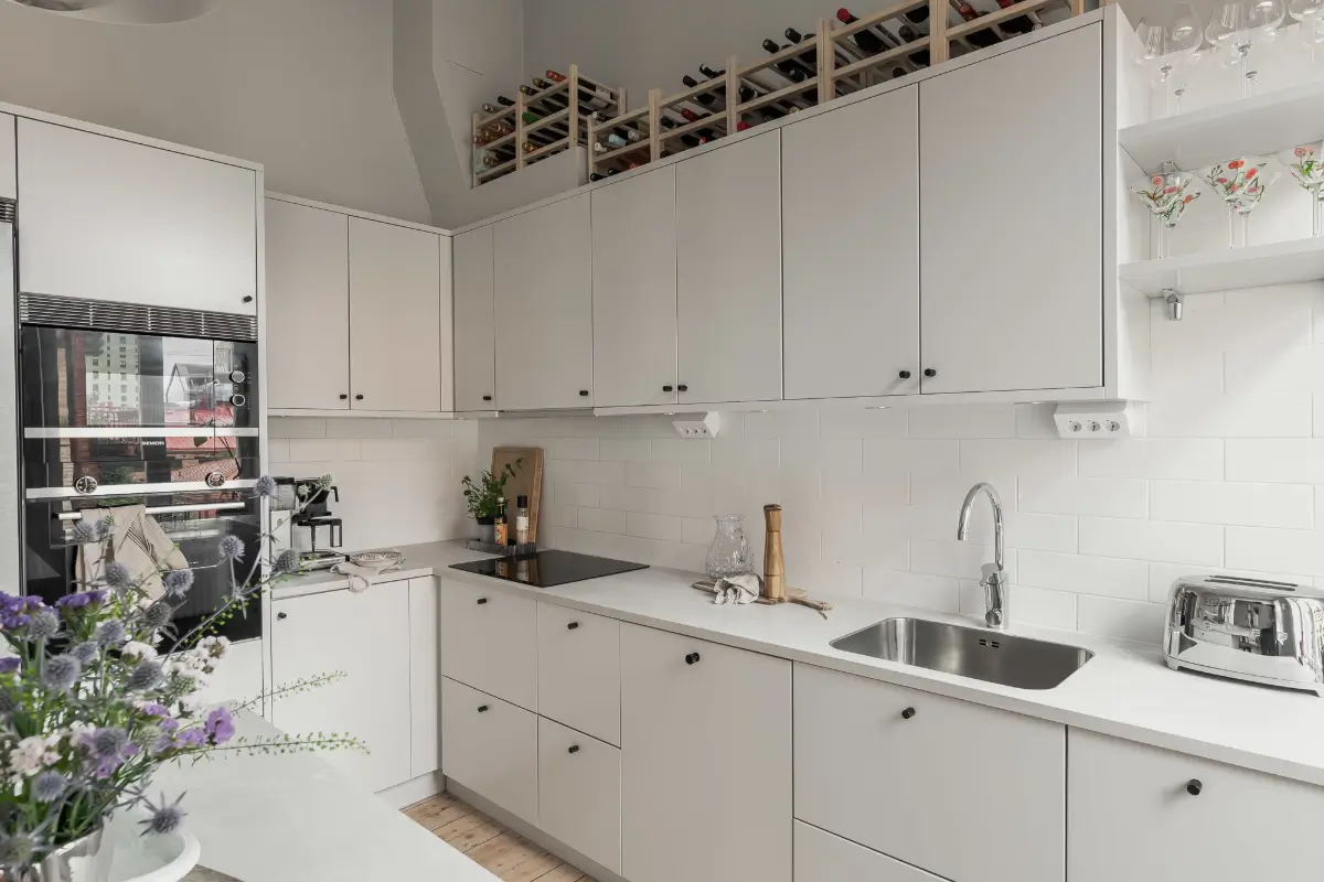 A Gray Scandinavian Apartment with a Royal History 12 white kitchen cabinets