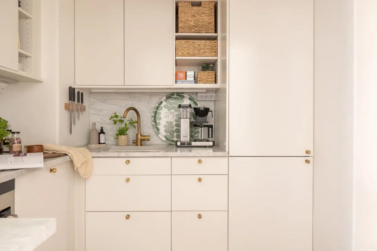 A Small Beige Stockholm Apartment with Plenty of Storage 14 white kitchen gold knobs