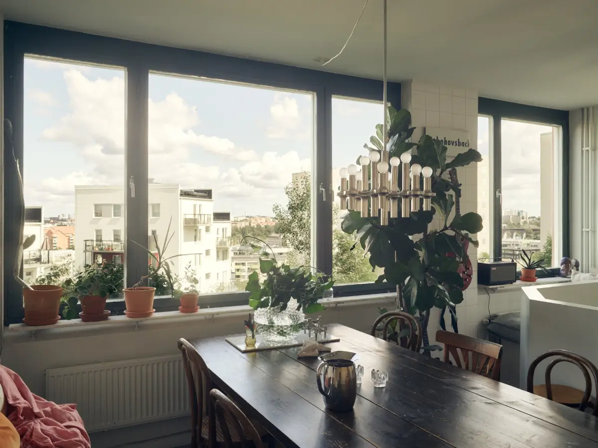 Industrial Elements in a 1960s Duplex Apartment in Stockholm 26 wooden dining table large windows