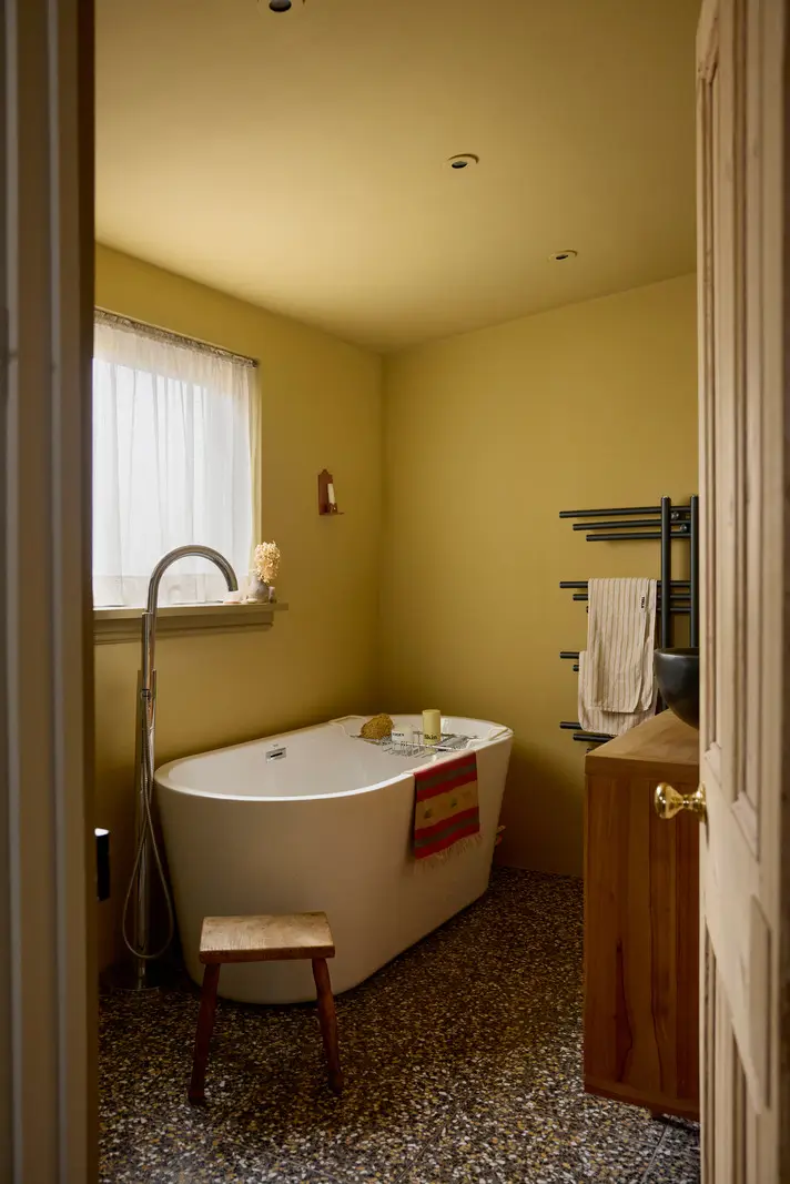 A Victorian Home with a Rich Color Palette and a Lush Garden 19 yellow bathroom terrazzo floor