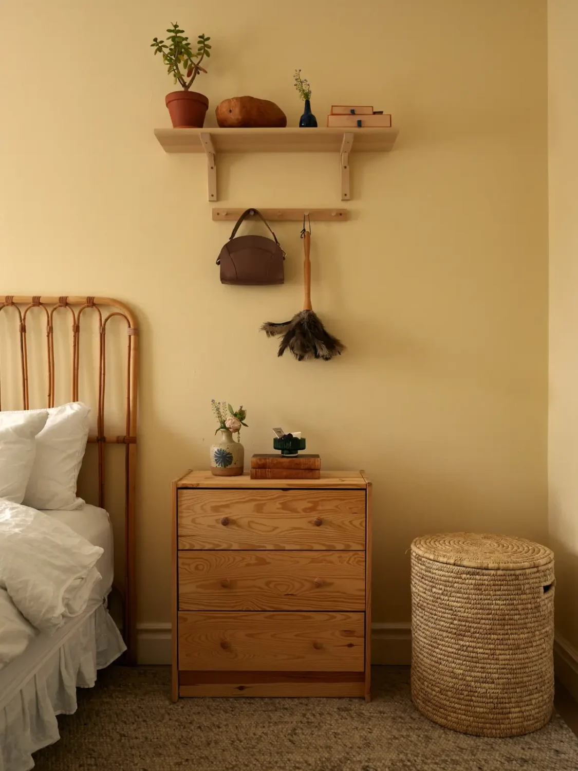 A Muted Color Palette in a Cozy 1920s Apartment in Stockholm 14 yellow bedroom rattan furniture nordroom