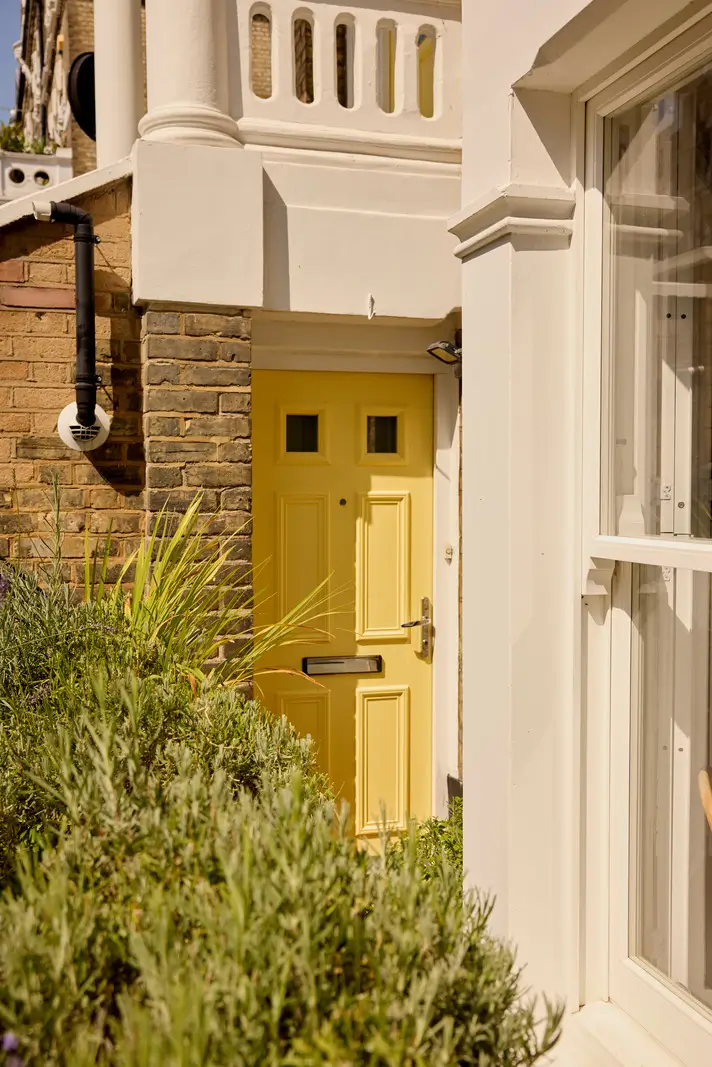 Pastel Hues in a Two-Bedroom Garden Apartment in West Kensington 22 yellow front door