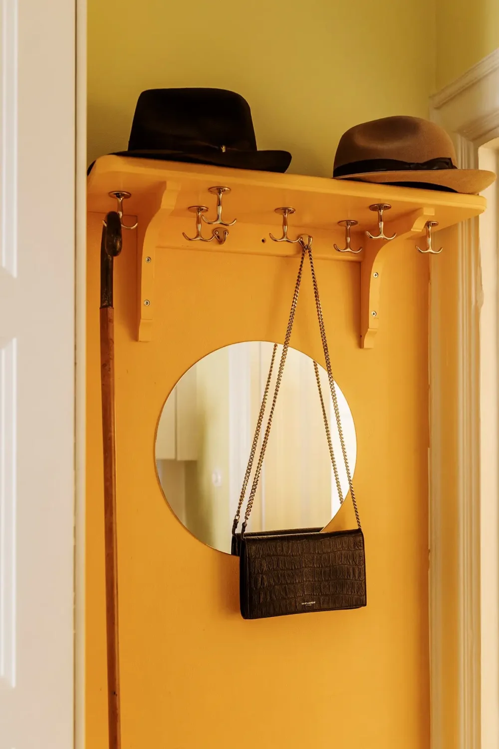 A Farrow & Ball Palette in an Art Nouveau Stockholm Apartment 19 yellow hall with coat rack