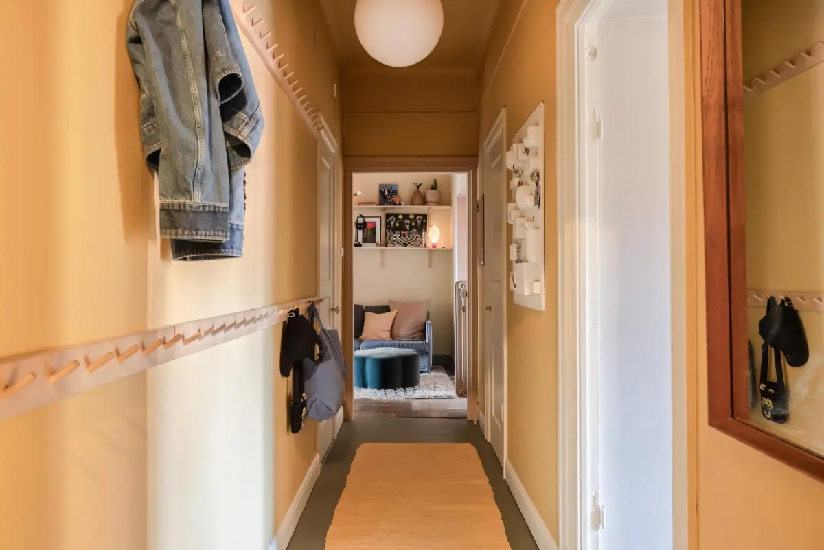 Colorful Rooms in a Practical Stockholm Family Apartment 22 yellow hall with wooden hooks