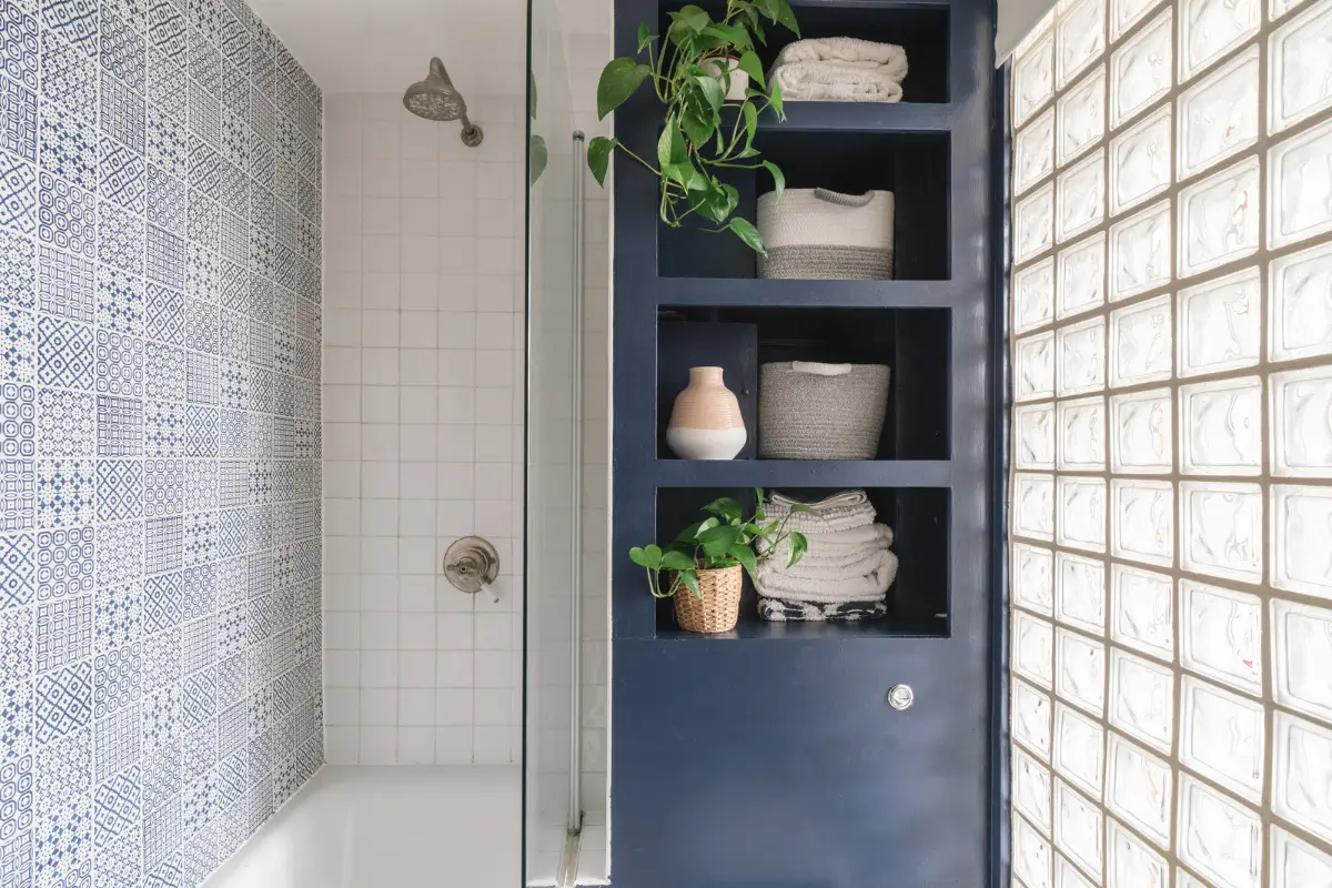 A Bright and Cozy One-Bedroom Apartment in London 14 bathroom blue built-in shelves patterned tiles