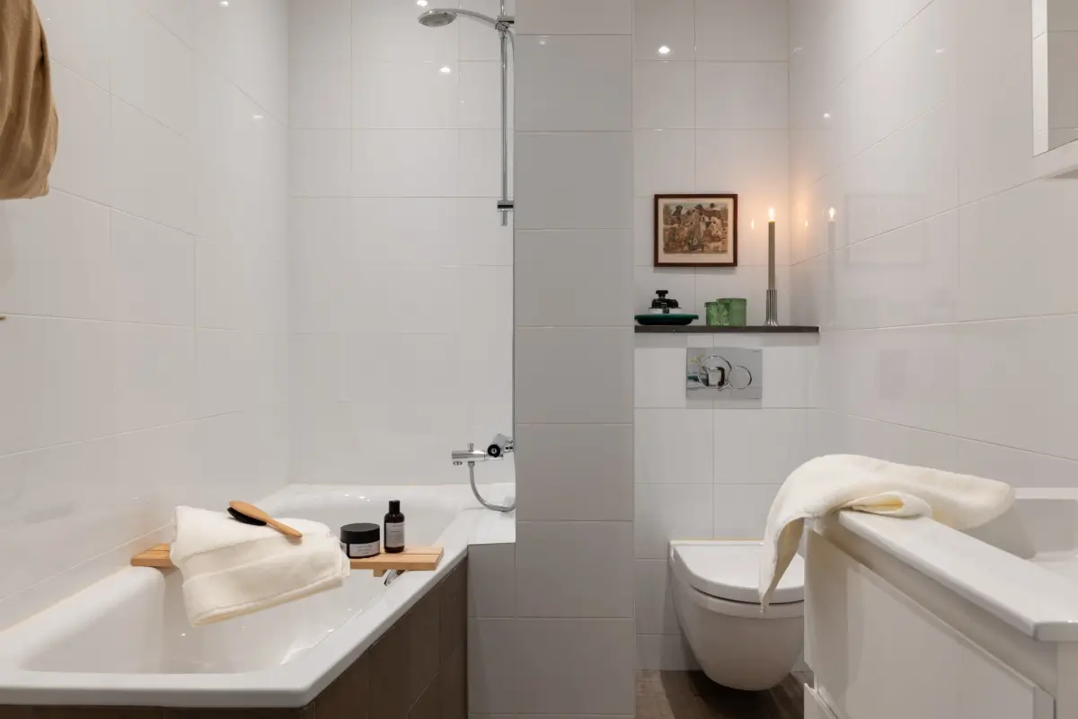 A Warm Color Palette in a Cozy 1920s Apartment in Stockholm 27 bathroom with combined bath and shower