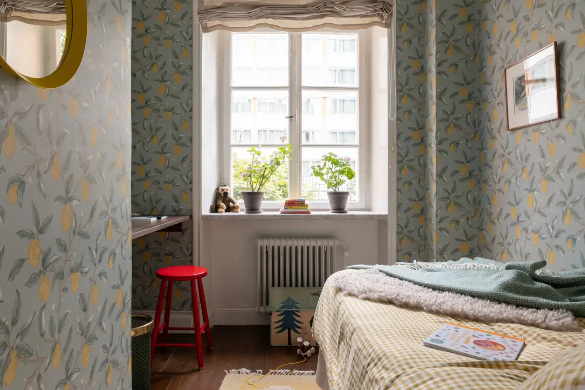 A Warm Color Palette in a Cozy 1920s Apartment in Stockholm 24 bedroom lemon wallpapaper small built-in desk