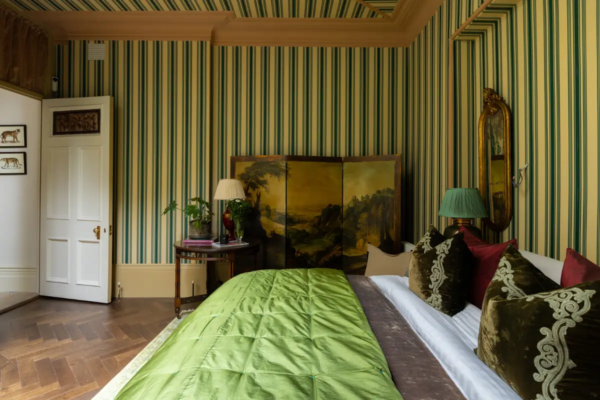 A Mixture of Patterns, Colors, and Materials in a Stunning London Apartment 18 bedroom striped wallpaper herringbone floor