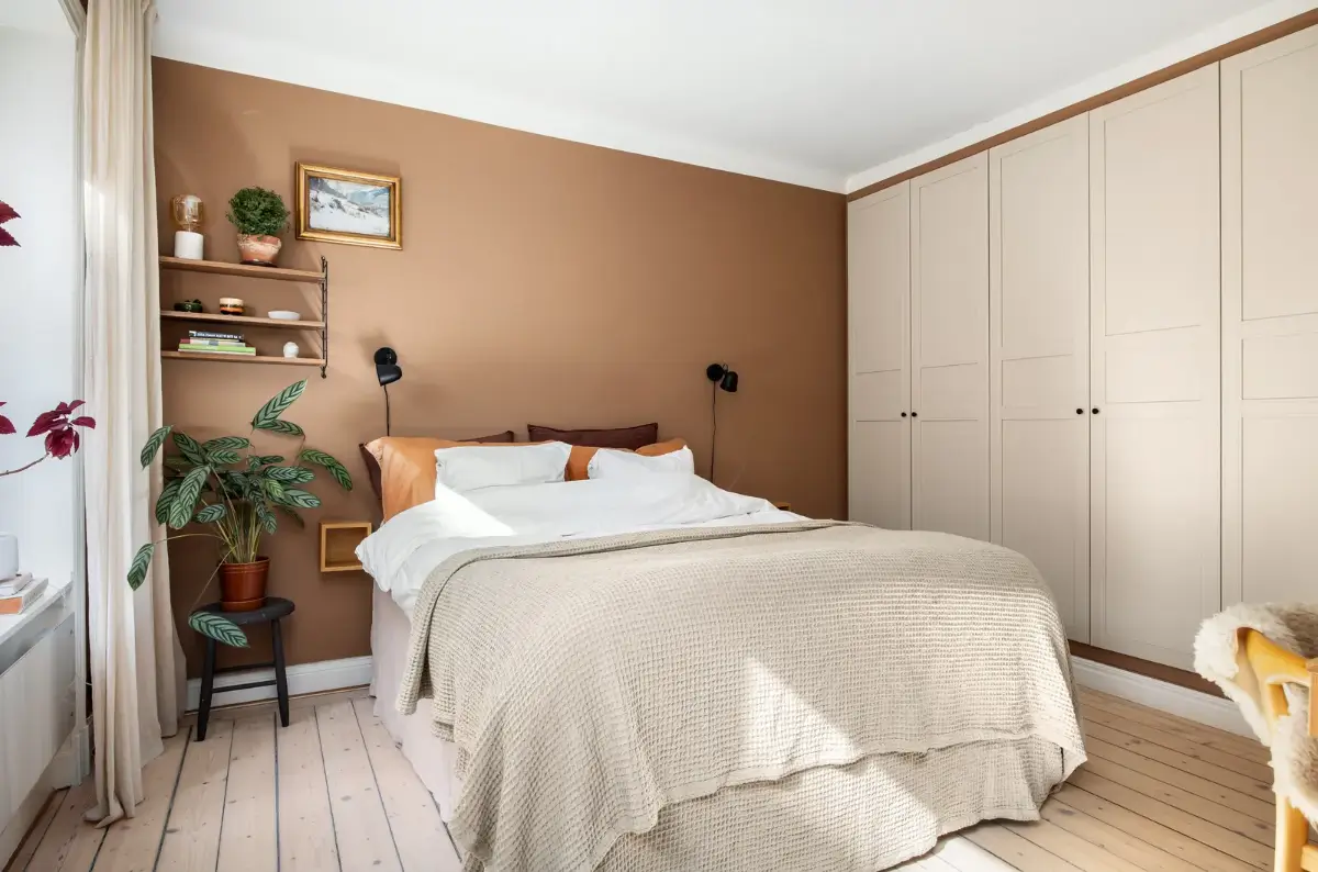 Warm Colors and an Open-Plan Living Space in a Stockholm Apartment 11 bedroom terracotta wall color built-in wardrobes