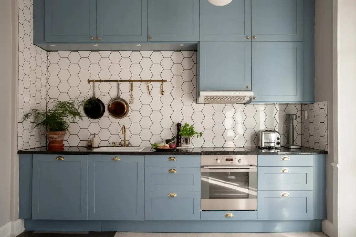 A Light Turn-of-the-Century Apartment with a Blue Kitchen 11 blue kitchen hexagon backsplash tiles