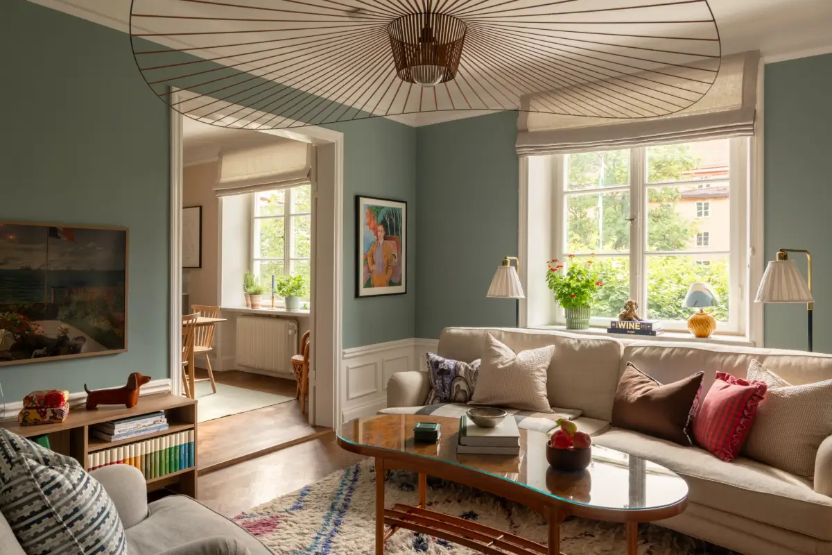 A Warm Color Palette in a Cozy 1920s Apartment in Stockholm 11 blue living room parquet floor