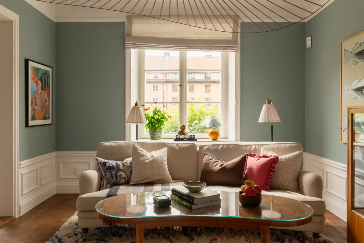 A Warm Color Palette in a Cozy 1920s Apartment in Stockholm 12 blue living room sofa
