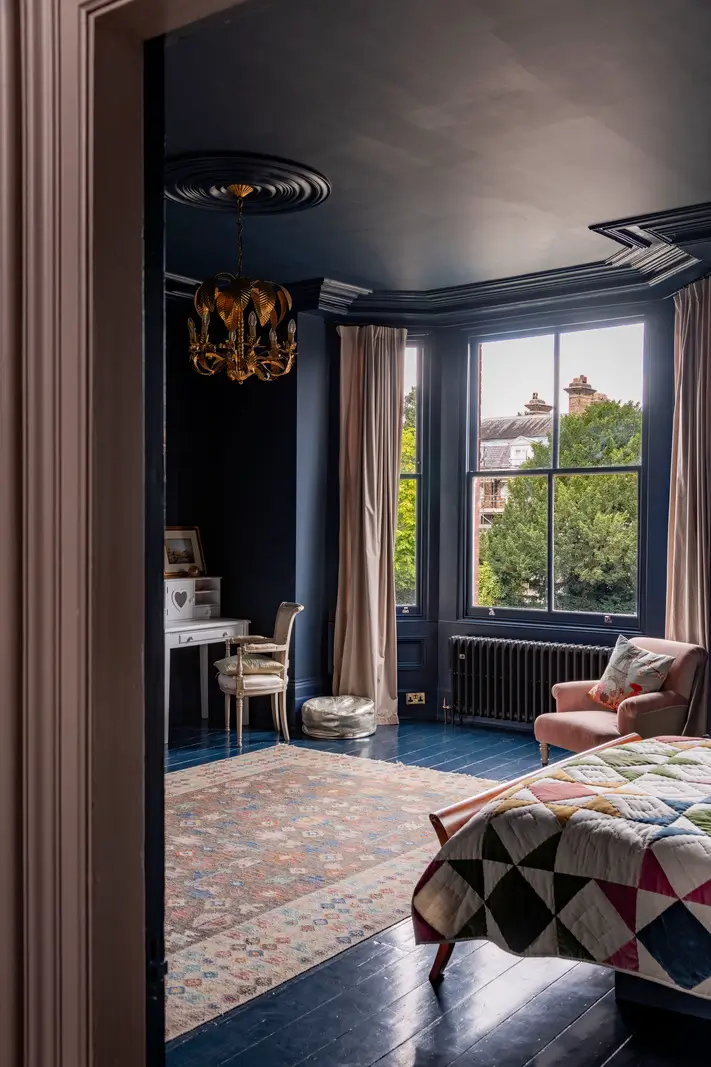 A Dramatic Color Palette in a Large Victorian Family Townhouse 20 color drenched dark blue master suite bay window