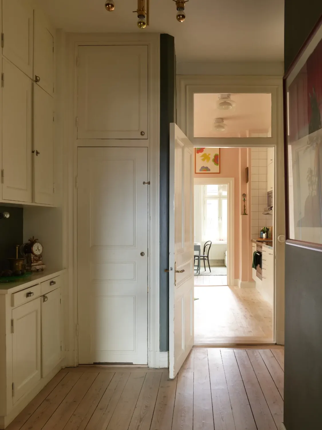 A Spacious Family Apartment with Original Details in Stockholm 21 dark blue hall original built-in cabinets