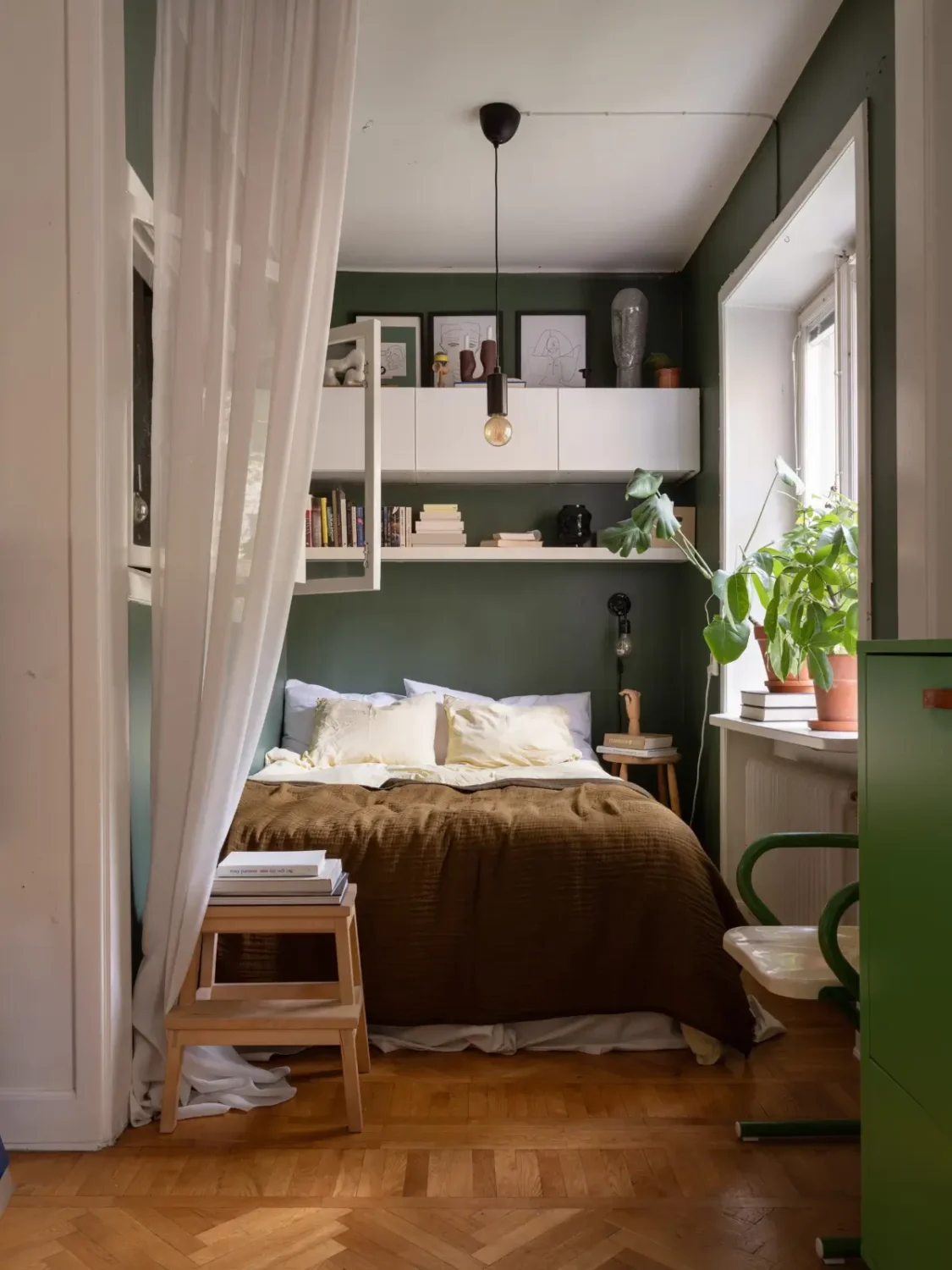 Studio Apartment Layout Ideas: Living Small is Looking Good 36 dark green bed nook with shelves and high cabinets