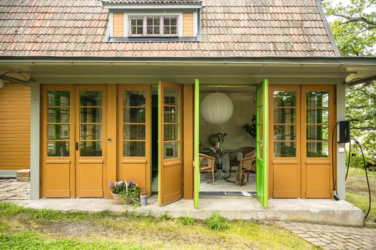 A Cozy Early 20th-Century Home with Views of Lake Mälaren in Sweden 35 garden room yellow exterior swedish villa