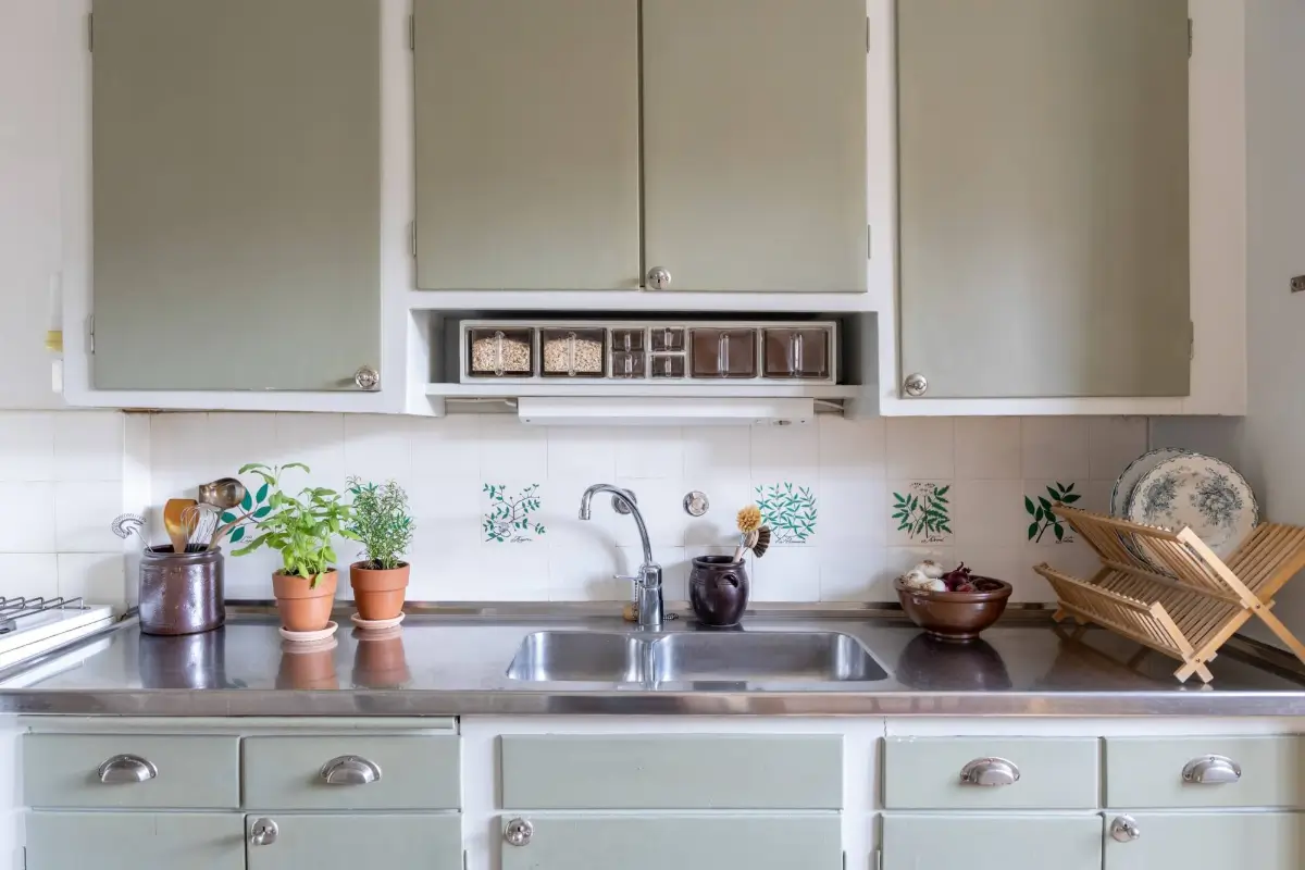 Warm Tones, Antiques, and Period Features in a Swedish Studio Apartment 16 gray-green kitchen cabinet doors