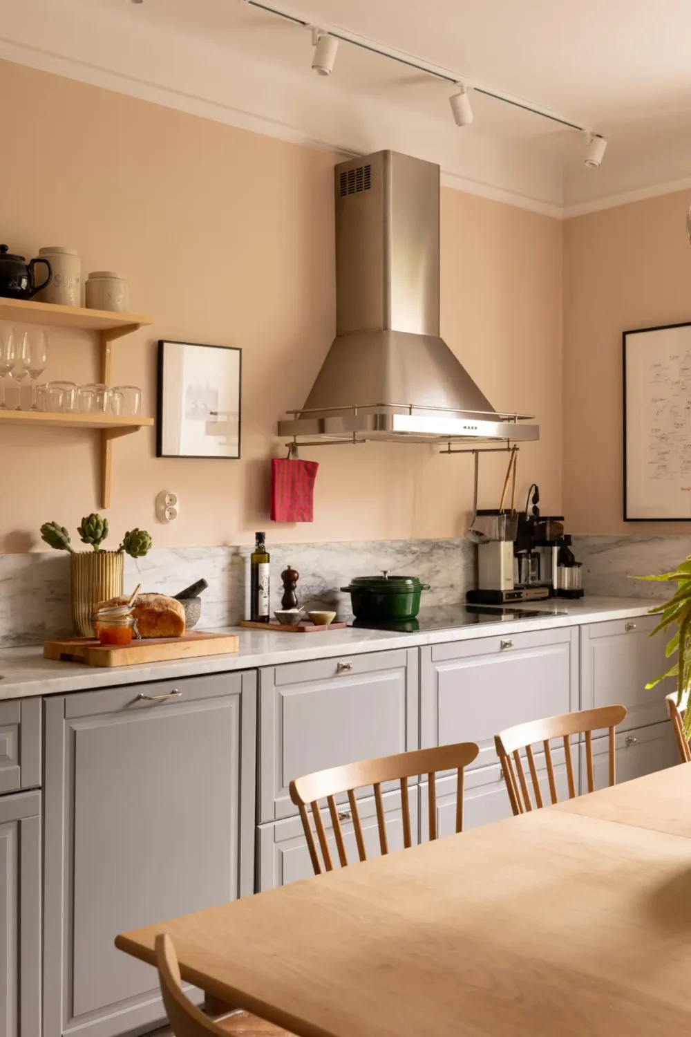 A Warm Color Palette in a Cozy 1920s Apartment in Stockholm 4 gray kitchen cabinets light terracotta wall color