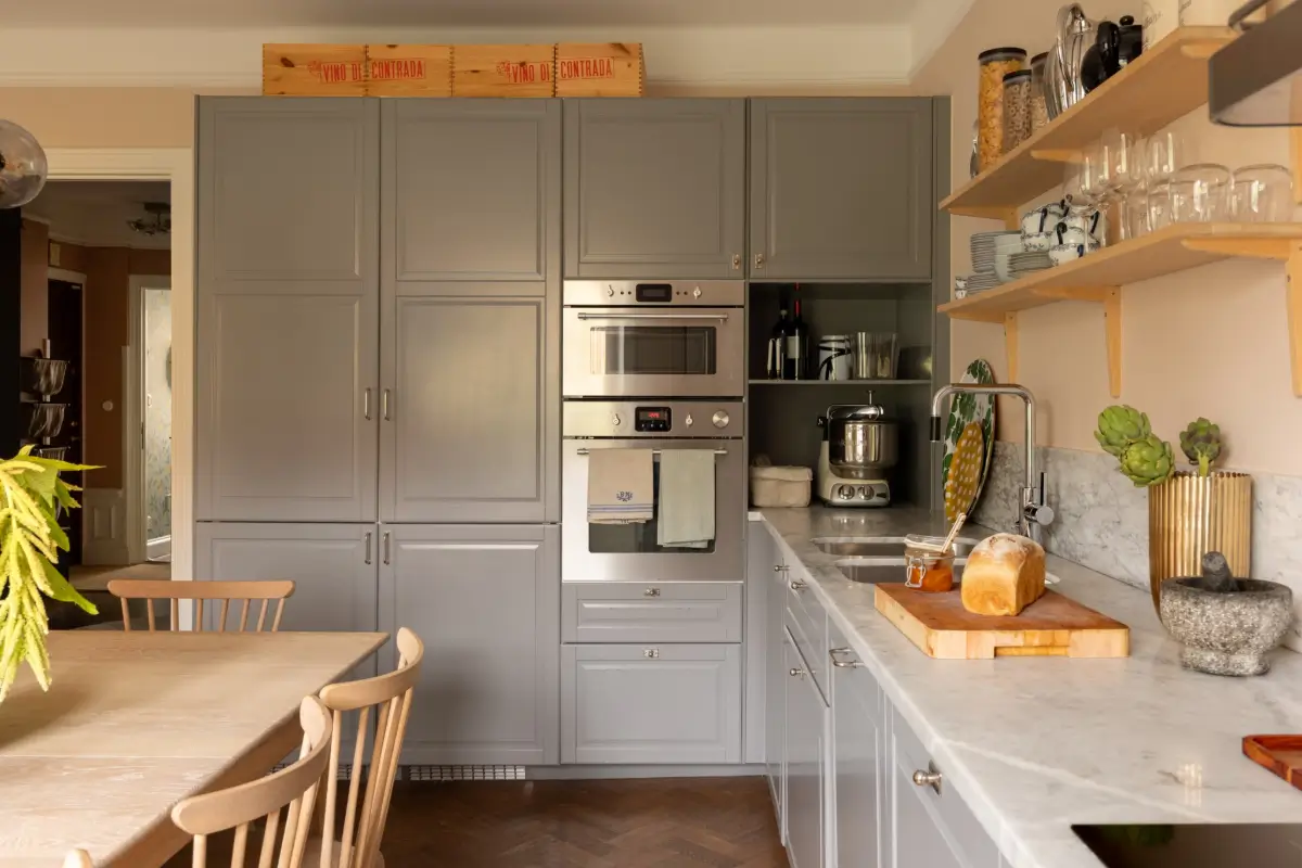 A Warm Color Palette in a Cozy 1920s Apartment in Stockholm 5 gray kitchen cabinets