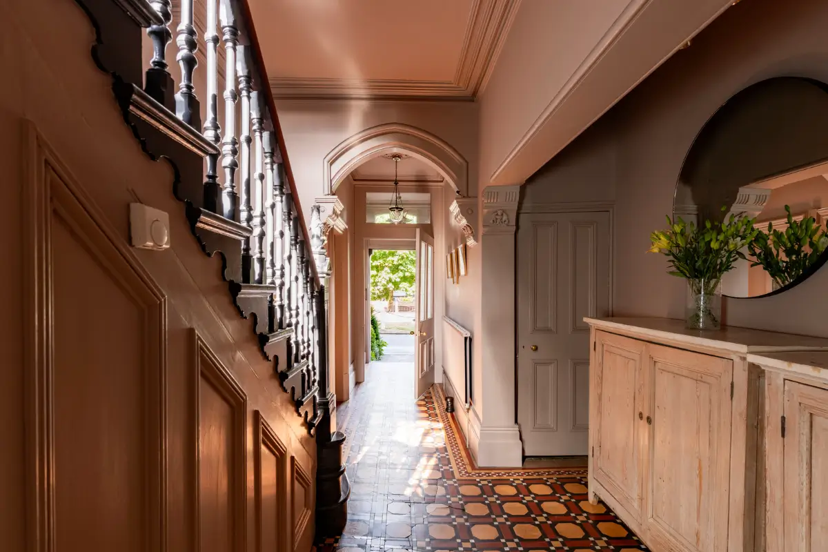 A Dramatic Color Palette in a Large Victorian Family Townhouse 16 hall arched doorway original floor tiles