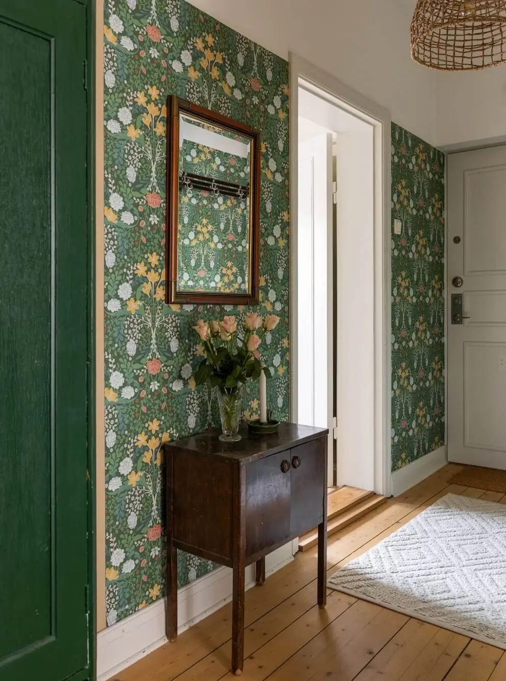 Warm Tones, Antiques, and Period Features in a Swedish Studio Apartment 18 hall green wallpaper