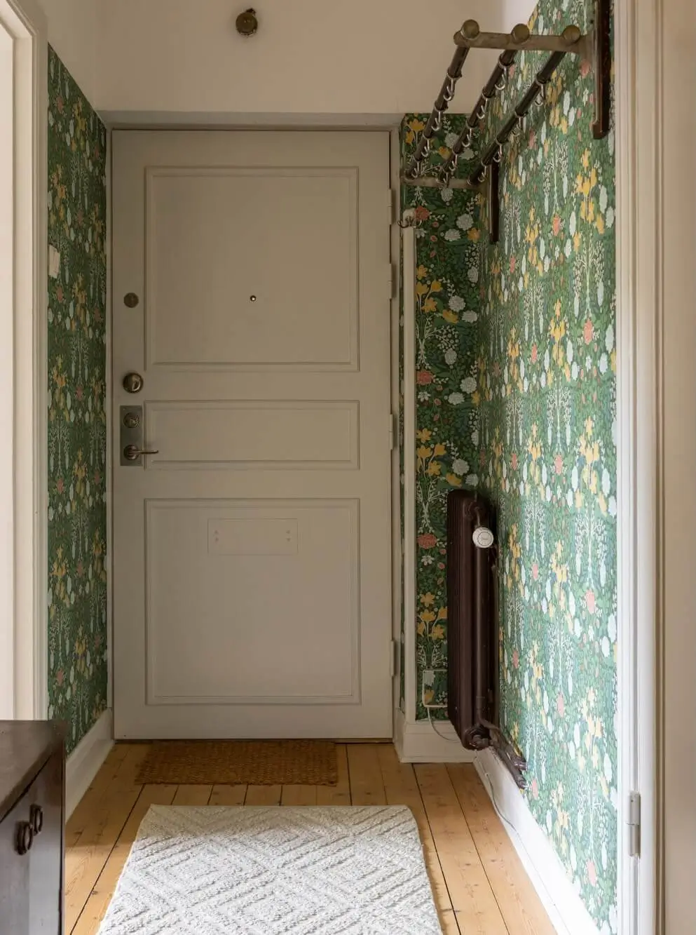 Warm Tones, Antiques, and Period Features in a Swedish Studio Apartment 21 hall green william morris wallpaper Warm Tones, Antiques, and Period Features in a Swedish Studio Apartment