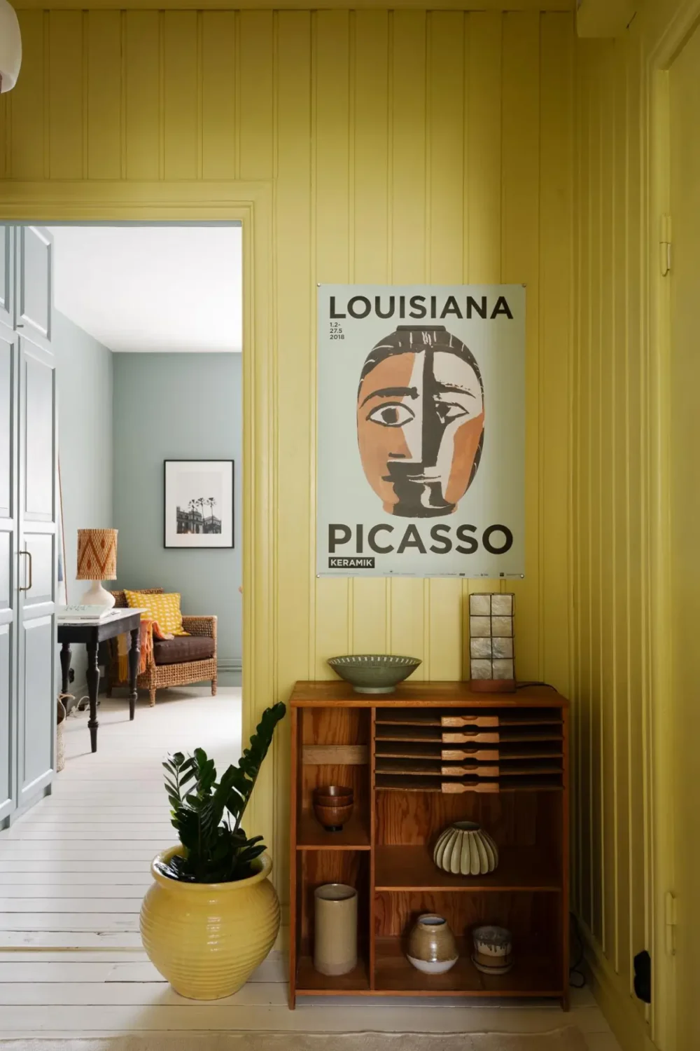 Historic Character and Color in a Swedish Studio Apartment 11 hall open cabinet yellow paneling
