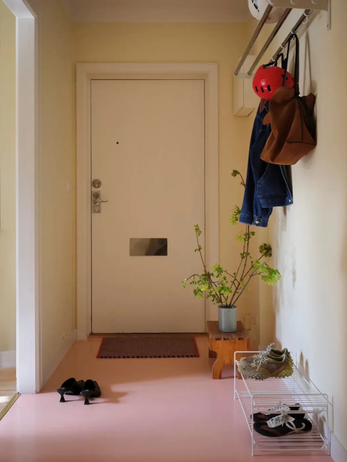 Soft Beige Interiors with the Occasional Bright Color Pop in Stockholm 30 hall yellow walls pink floor nordroom Soft Beige Interiors with the Occasional Bright Color Pop in Stockholm