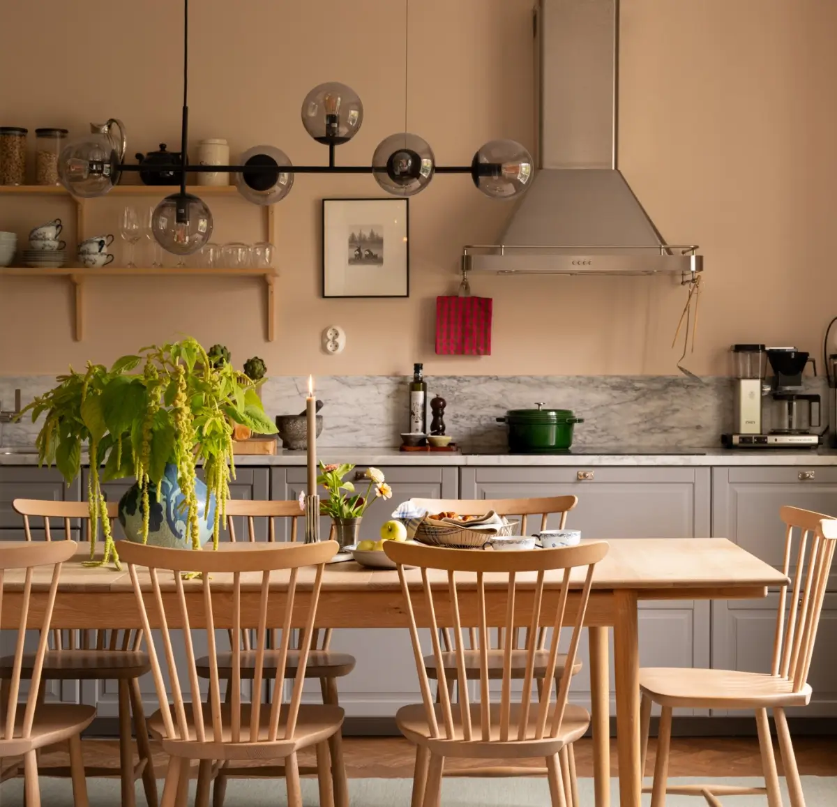 A Warm Color Palette in a Cozy 1920s Apartment in Stockholm 3 kitchen large wooden table