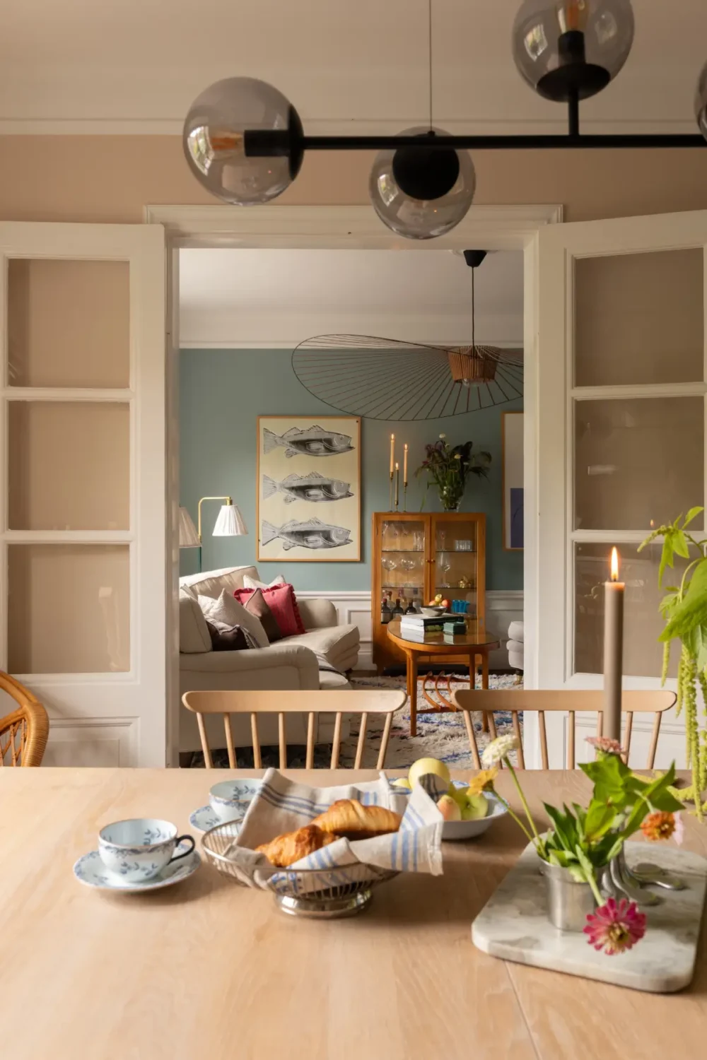 A Warm Color Palette in a Cozy 1920s Apartment in Stockholm 9 kitchen view into living room