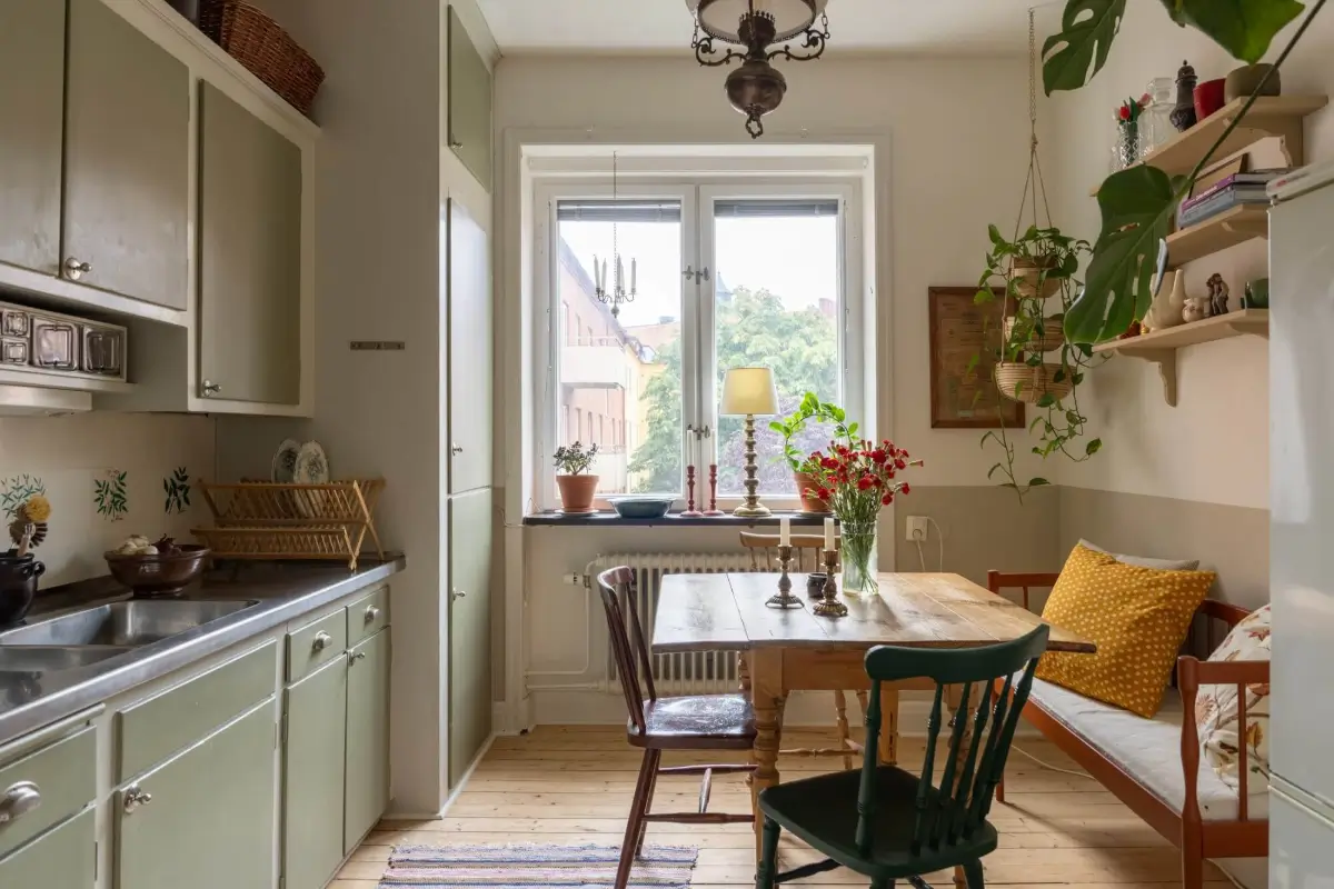 Warm Tones, Antiques, and Period Features in a Swedish Studio Apartment 13 kitchen vintage wooden table bench half-painted wall