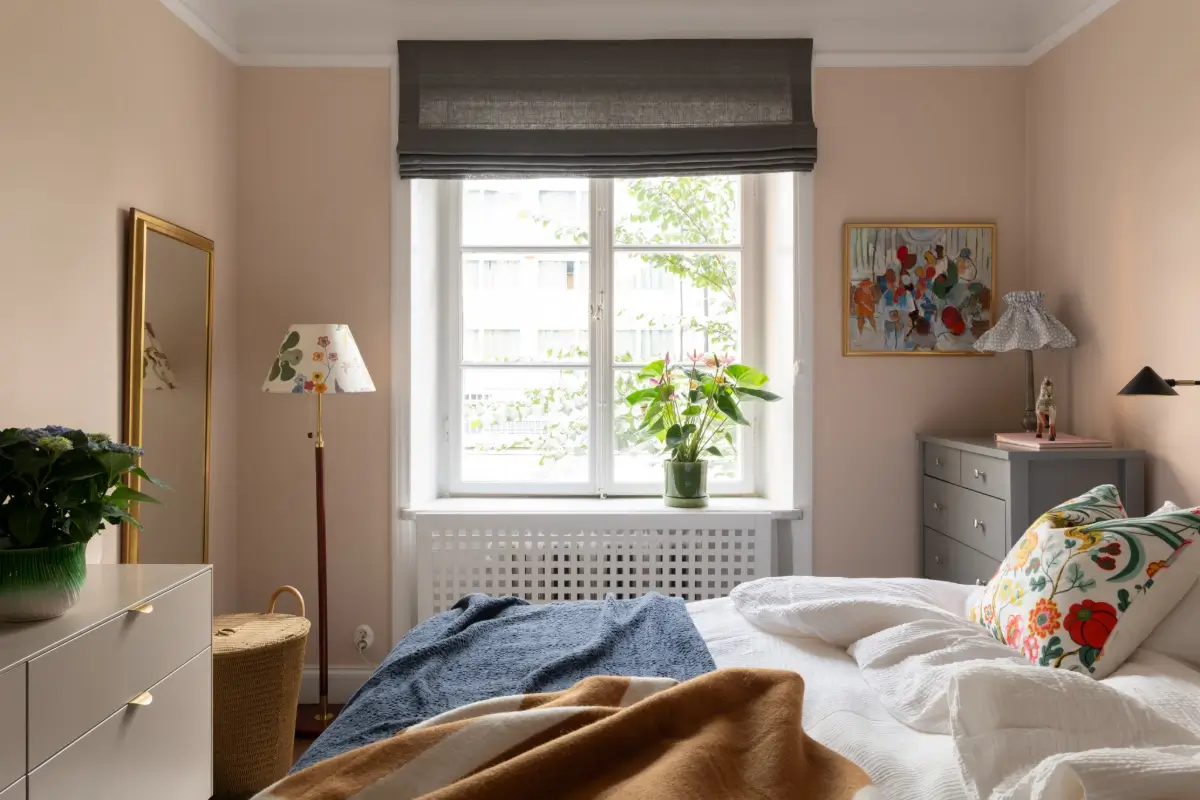 A Warm Color Palette in a Cozy 1920s Apartment in Stockholm 21 light pink bedroom