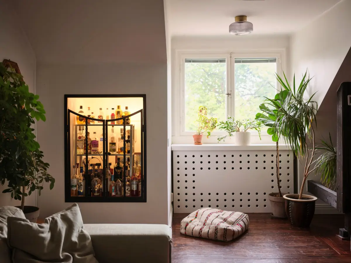 Exposed Beams and Dark-Stained Floorboards in a Cozy Attic Apartment 7 living room home bar