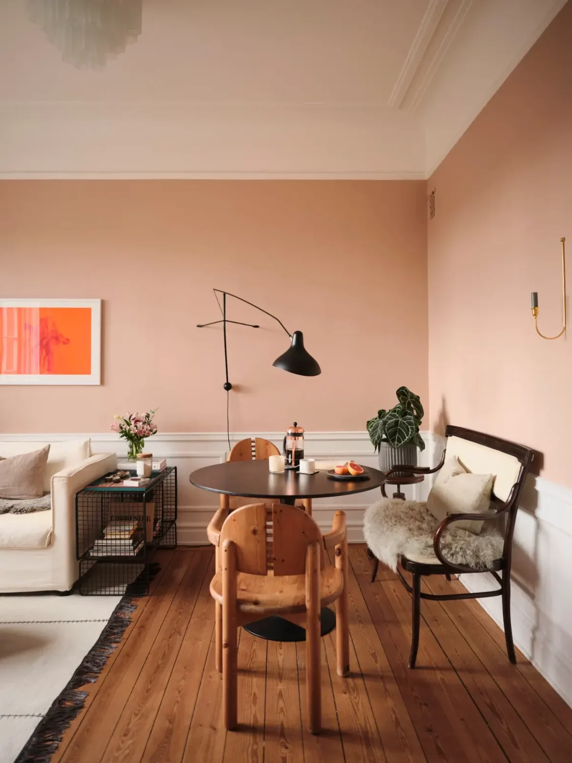 Best of 2025: Living Rooms 64 living room warm pink walls wooden floorboards black round dining table nordroom