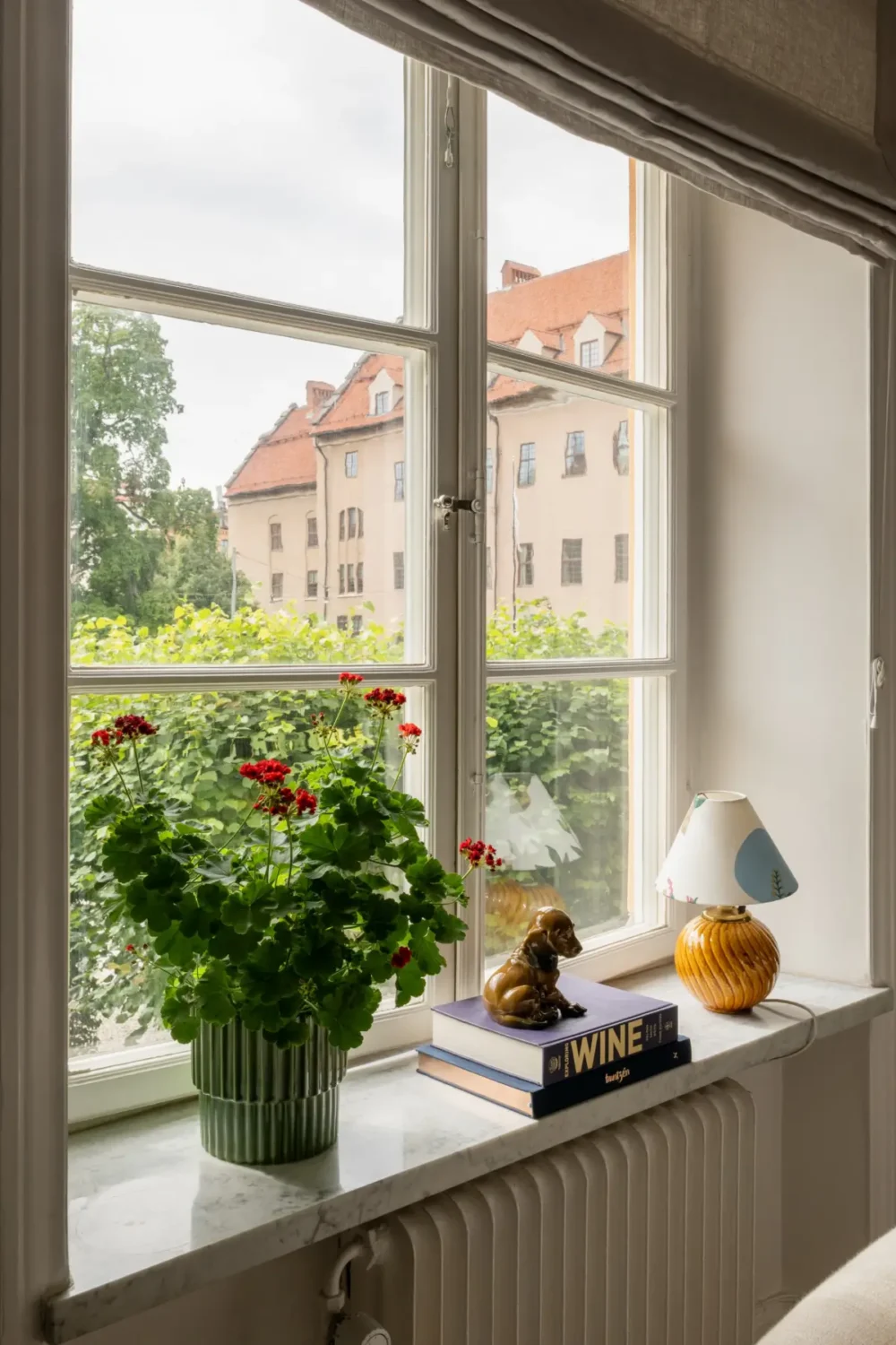 A Warm Color Palette in a Cozy 1920s Apartment in Stockholm 13 living room window