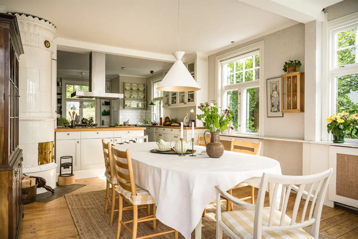 A Cozy Early 20th-Century Home with Views of Lake Mälaren in Sweden 10 open plan kitchen dining room fireplace