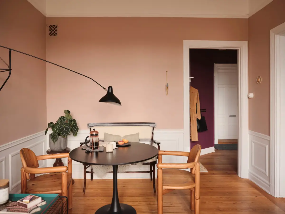 Warm Pink Walls and a Glass Room Divider in a Small Stockholm Apartment 7 pink living room dining table with bench