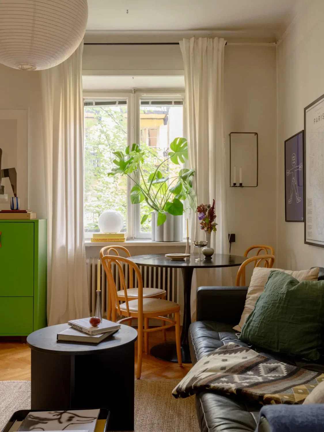 A 1920s Studio Apartment with a Forest Green Sleeping Alcove 3 round black table