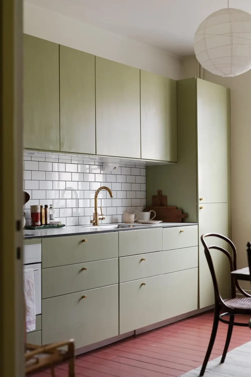 Historic Character and Color in a Swedish Studio Apartment 16 sage green kitchen white backsplash