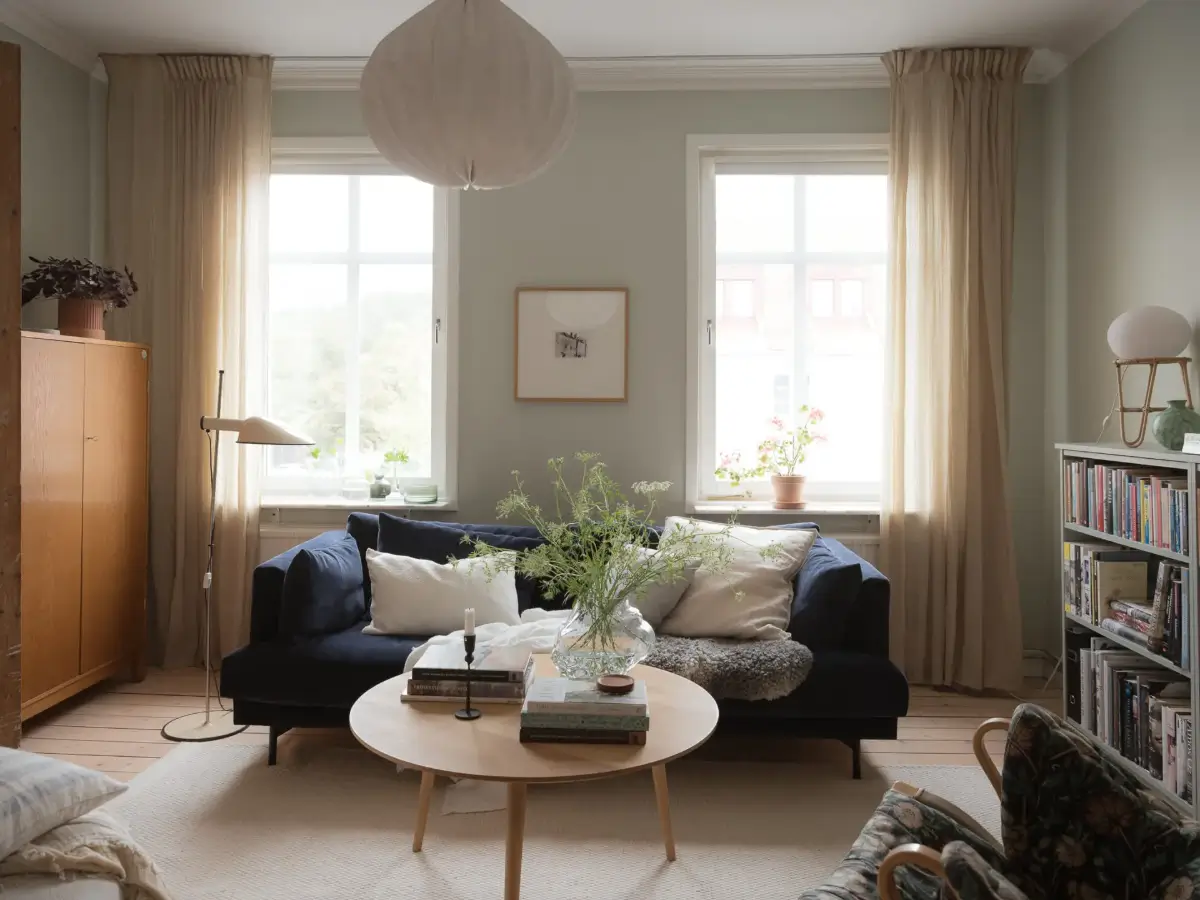A Cozy Apartment with Exposed Brick and Period Details 6 scandi living room dark blue sofa