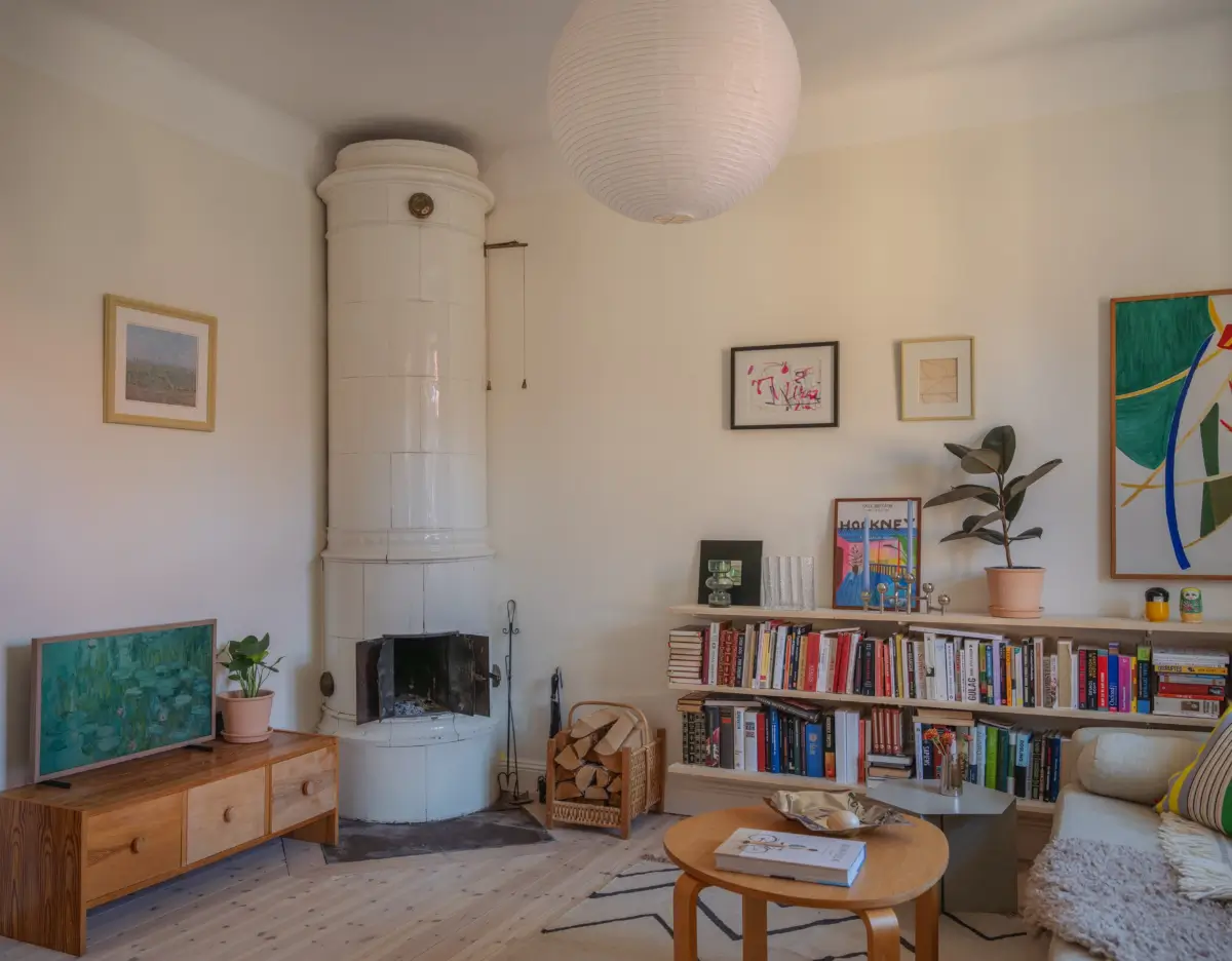 A Bright Apartment Where Historic Character Meets Contemporary Design 1 scandi living room fireplace bookshelves
