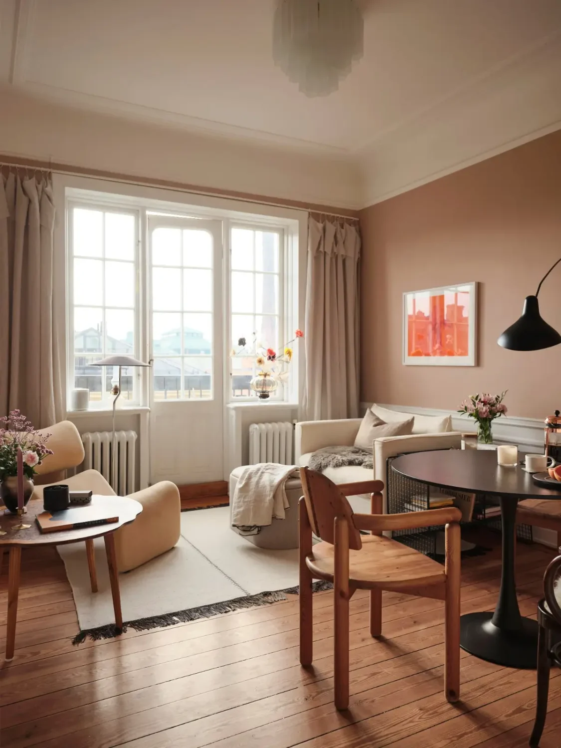 Warm Pink Walls and a Glass Room Divider in a Small Stockholm Apartment 3 scandi living room pink walls wooden floorboards