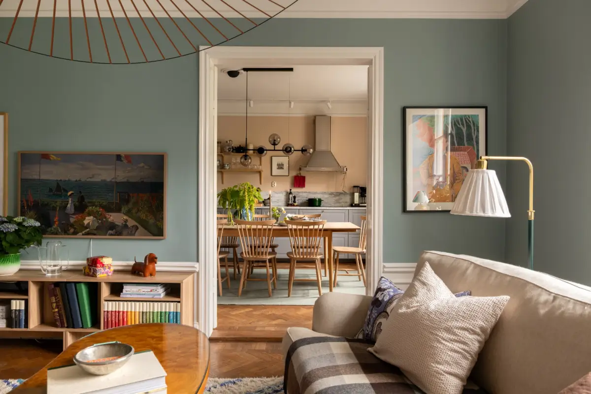 A Warm Color Palette in a Cozy 1920s Apartment in Stockholm 10 social living room kitchen layout