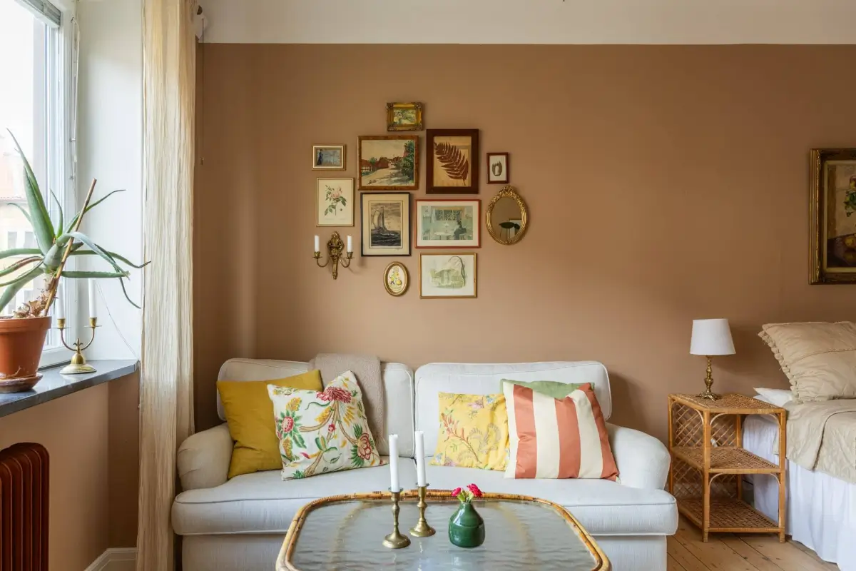 Warm Tones, Antiques, and Period Features in a Swedish Studio Apartment 3 studio apartment small antique gallery wall