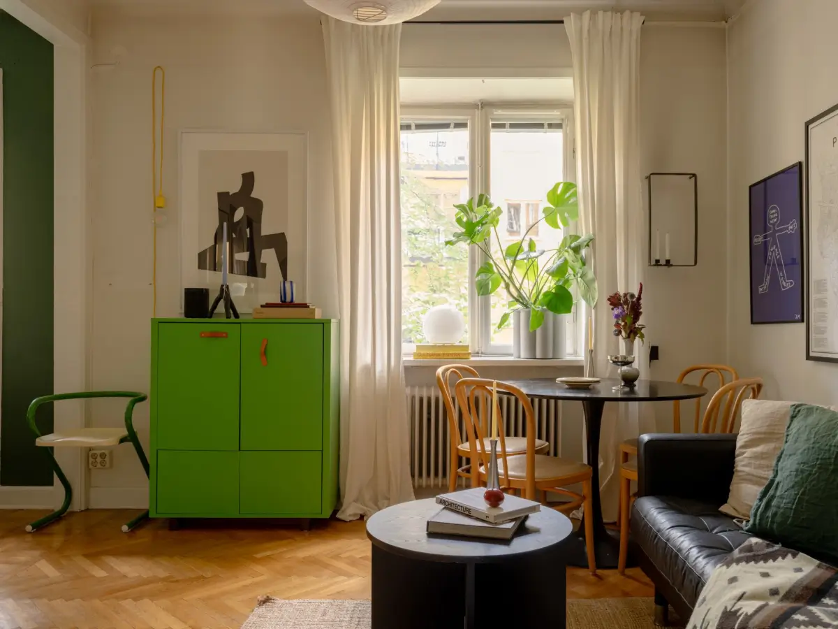 A 1920s Studio Apartment with a Forest Green Sleeping Alcove 5 studio parquet floor black sofa round table