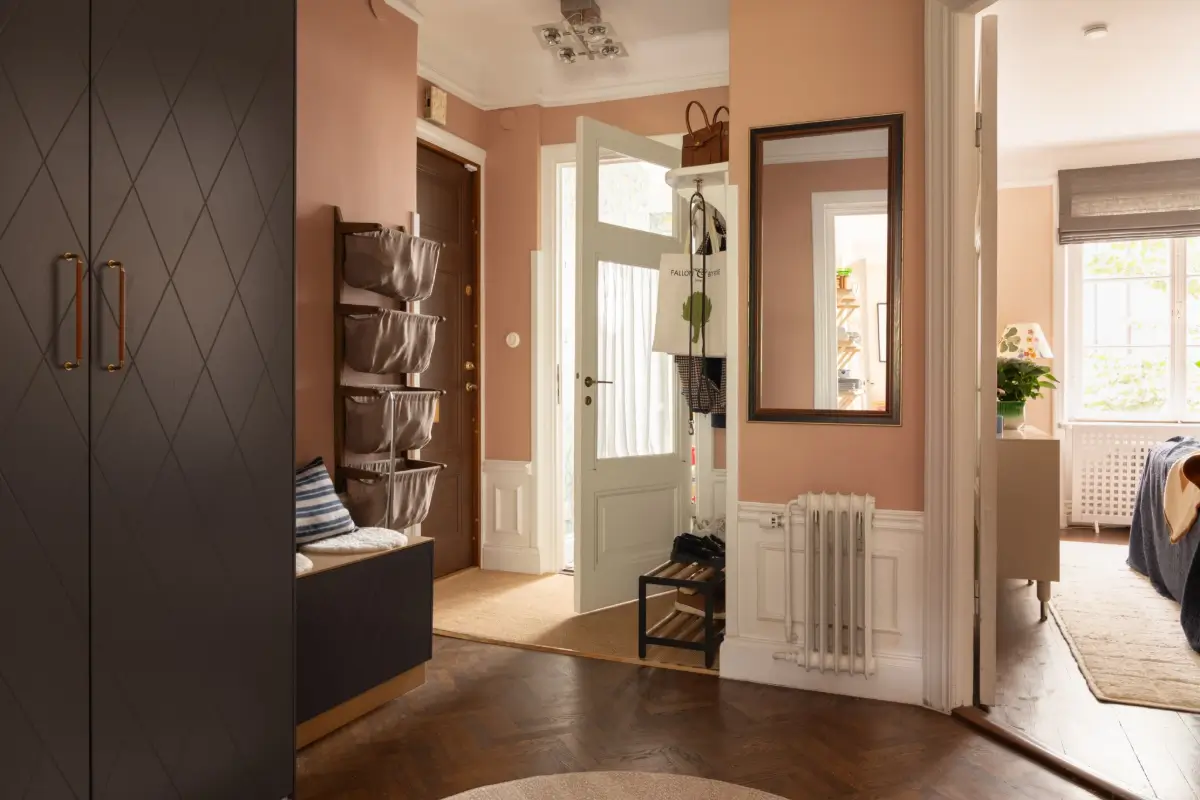 A Warm Color Palette in a Cozy 1920s Apartment in Stockholm 17 terracotta hall with wardrobes and bench